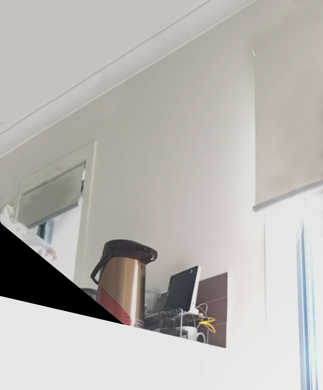 Image of neutral wall with tiling and items in foreground including Telstra modem.