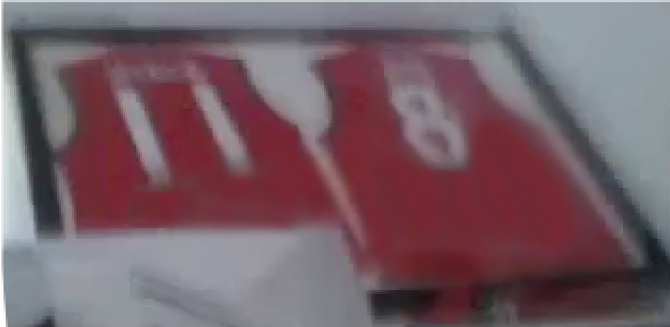 Two framed red jerseys, showing number 11 and number 8.